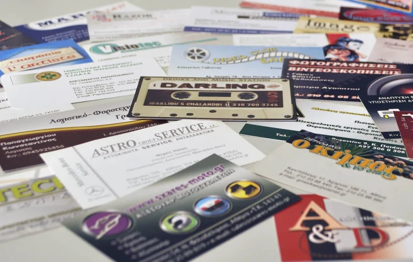 Many business cards for different clients spread out on a table