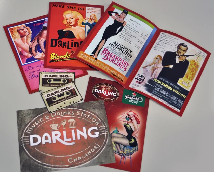 Darling Music & Drinks Station menus, cassette-shaped cards and logo, with covers styled as old movie posters