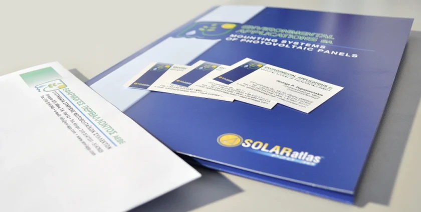 The blue Environmental Applications presentation folder with business cards and an envelope