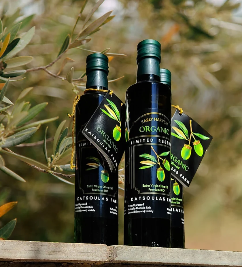 Bottles of Katsoulas Farm organic olive oil labelled “Early Harvest Organic”, outdoors
