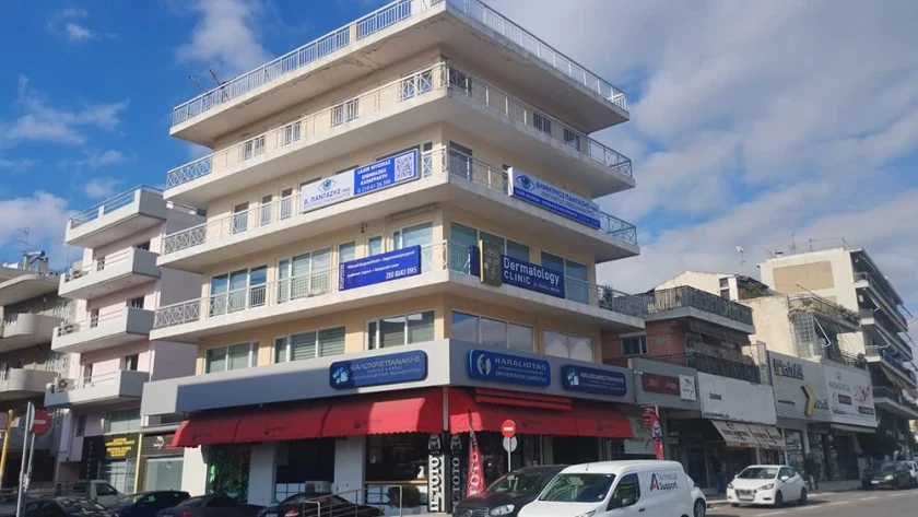 Building front with blue signs of medical practices, including that of D. Pantazis