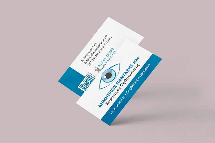 Business cards of eye surgeon Dimitrios Pantazis in white and blue, with an eye logo and a QR code