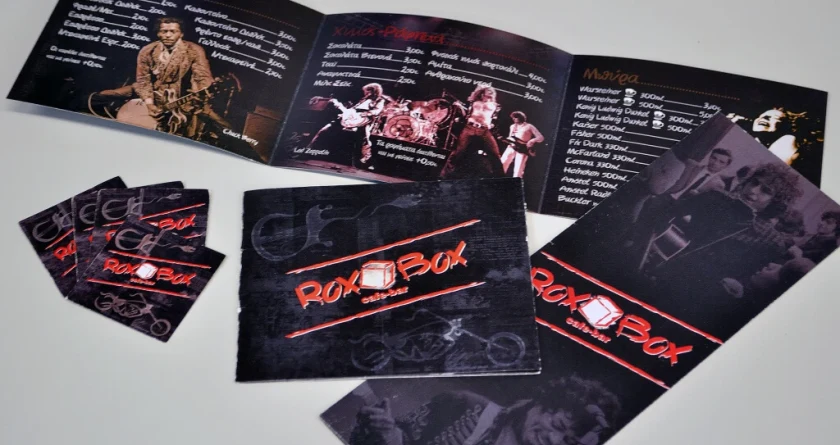 Ο ανοιχτός κατάλογος του Rox Box με φωτογραφίες rock συναυλιών, δίπλα σε κάρτες και εξώφυλλα